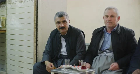 Portrait of Men As They Sit, Relax And Drink Tea Near The Citadel in Erbil, Iraq Stock Footage 150284095