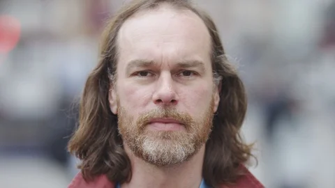 Portrait of middle aged bearded man smiling to camera, in slow motion Stock Footage 92473975