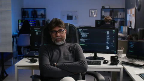 Portrait of Middle Aged Cybersecurity Analyst Sitting in Tech Office Stock Footage 347302447