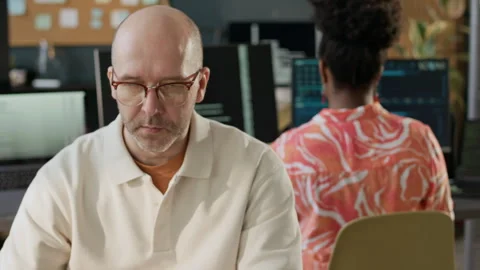 Portrait of Middle-Aged Male Software Engineer Working in Open Space Office Stock Footage 306839240
