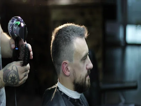 Portrait of the middle aged man in backlight at a barbershop. Stock Footage 80262367