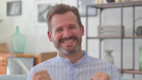 Portrait of Middle Aged Man Cheering Win while at Home Stock Footage 287897339