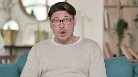 Portrait of Middle Aged Man Feeling Shocked at Home Video stock 142375745