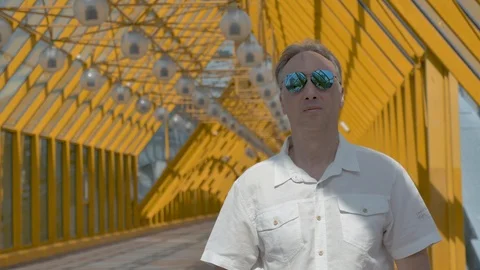 Portrait of a middle-aged man with gray hair in a white shirt and mirror glasses Video stock 112412314