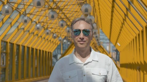 Portrait of a middle-aged man with gray hair in a white shirt and mirror glasses Video stock 112412664