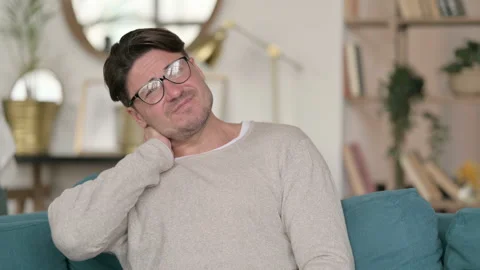 Portrait of Middle Aged Man having Neck Pain at Home 스톡 동영상 142376154