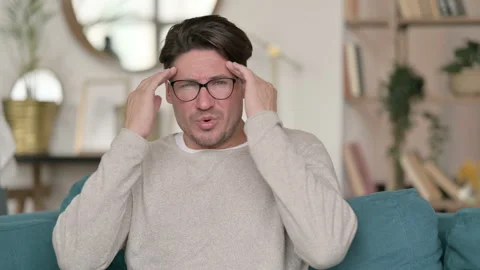 Portrait of Middle Aged Man having Headache at Home Video stock 142382413