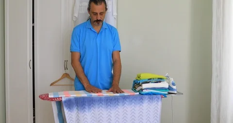 Portrait of middle aged man ironing clothes 2 Stock Footage 93567366
