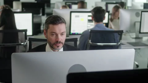 Portrait of Middle-Aged Man in Open Space Office Working on Decktop Computer Stock Footage 168799123