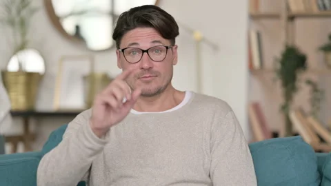 Portrait of Middle Aged Man Pointing with Finger at Home Video stock 142371465