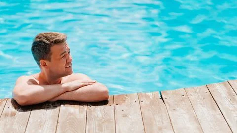 Portrait of a middle-aged man in the pool at the side. Stock Photos