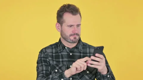 Portrait of Middle Aged Man Reacting to Loss on Smartphone Stock Footage 191555071