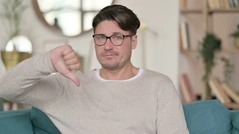 Portrait of Middle Aged Man with Thumbs Down at Home 스톡 동영상 142374938