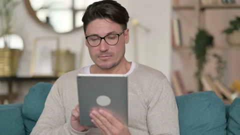 Portrait of Middle Aged Man using Digital Tablet at Home 스톡 동영상 142365739