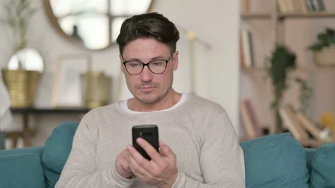 Portrait of Middle Aged Man using Smartphone at Home 스톡 동영상 142371039