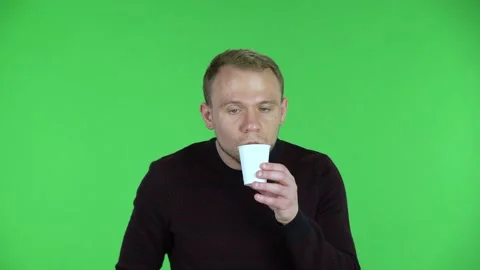 Portrait of a middle aged men drinking unpalatable coffee and is disgusted Stock Footage 148714535