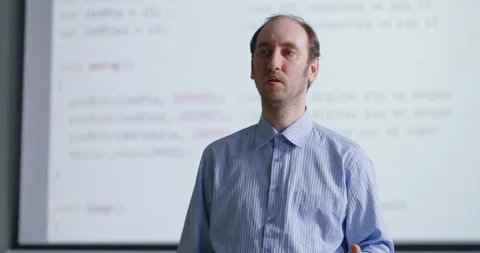 Portrait Of Middle-Aged School Teacher In Classroom Of Programming And Computer Stock Footage 283297583