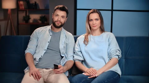 Portrait of middle-aged spouses in cozy living room, man and woman watching TV Stock Footage 279769723