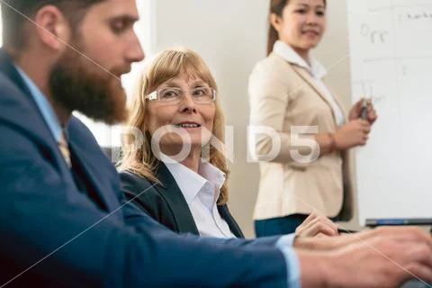 Portrait of a middle-aged woman during business meeting Stock Photos