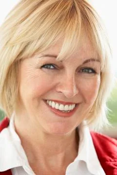 Portrait Of Middle Aged Woman Smiling At Camera Stock Photos