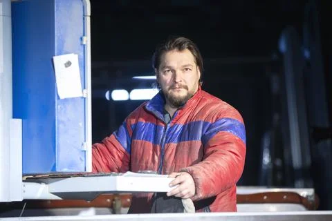 Portrait of a middle-aged working man in a dirty jacket. Stock Photos
