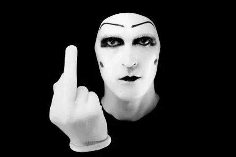 Portrait of the mime in white gloves. fuck you Stock Photos