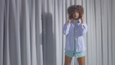 Portrait of mixed race dancer through the crystal wears pastel clothes on grey Stock Footage 127570573