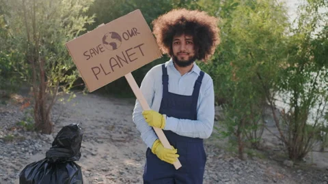 Portrait of Mixed Race Guy Eco Activist Looking to Camera while Standing with Stock Footage 148186942