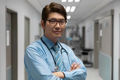 Portrait of mixed race male doctor standing in hospital corridor Stock Photos