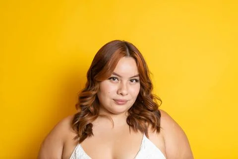 Portrait of mixed race redhead plus size model looking at camera Stock Photos