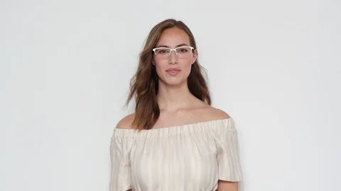 Portrait of a Model with Eyeglasses Posing for the Camera on White Background 스톡 동영상 116915475