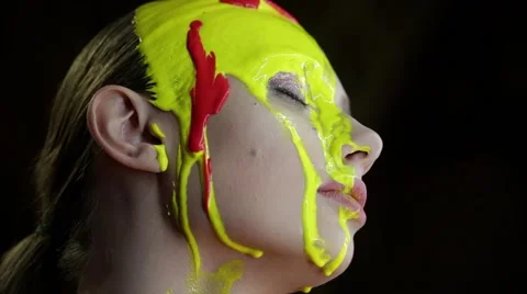 Portrait of a model with a flowing down paint on the face. Stock Footage 67318158