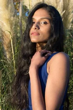 Portrait of model posing in front of Pampas grass in Sligo in Ireland. Stock Photos
