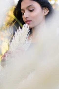 Portrait of model posing with Pampas grass in front of face. Stock Photos