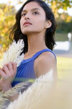 Portrait of model posing with Pampas grass in front of face. Stock Photos
