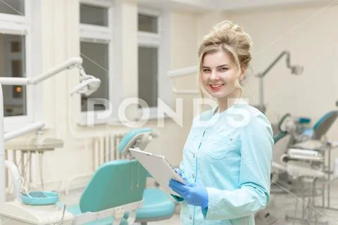 Portrait of modern dentist woman at work. Consultation the physician. Stock Photos