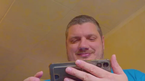 A portrait of a modern man looking at his smartphone screen Stock Footage 335382208