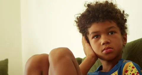 Portrait of a mulatto boy with an earache. He brings his hand to the affected Stock Footage 207463659