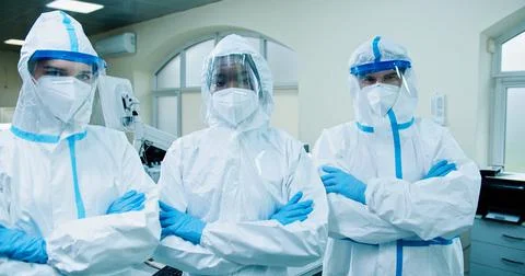 Portrait of multi-ethnic different doctors medical scientist in protective suits Stock Photos