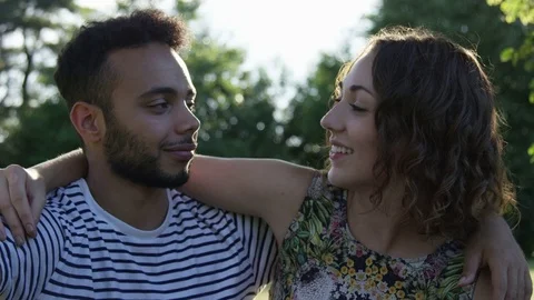 Portrait Multi-Ethnic Young Millennial Couple On A Date In The Park Looking Into Stock Footage 82619266