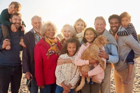 Portrait Of Multi-Generation Family Group With Dog On Winter Beach Vacation Stock Photos