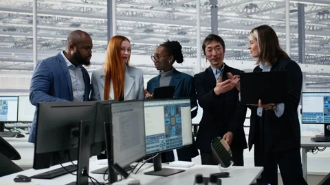 Portrait of multiethnic engineers reviewing microchip production operations Stock Footage 335880871