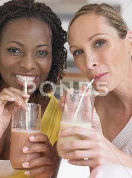 Portrait Of Multiethnic Women Drinking Milkshake Stock Photos