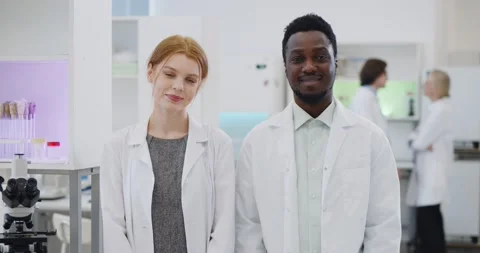 Portrait of multiethnic young scientists smiling at camera in modern laboratory Stock Footage 152158754