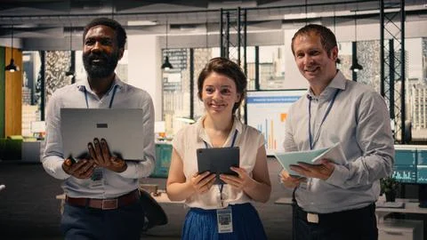 Portrait of multinational team collaborating on charts and business intelligence Stock Photos