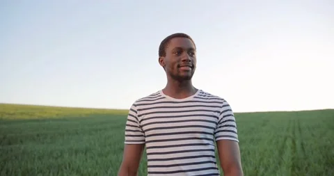 Portrait of multiracial male farmer walking through the large green multi Stock Footage 156416632