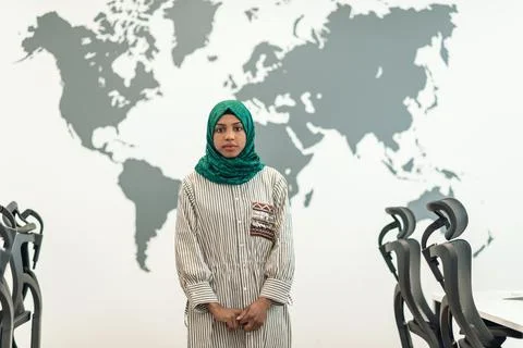 Portrait of muslim female software developer with green hijab standing at modern Stock Photos