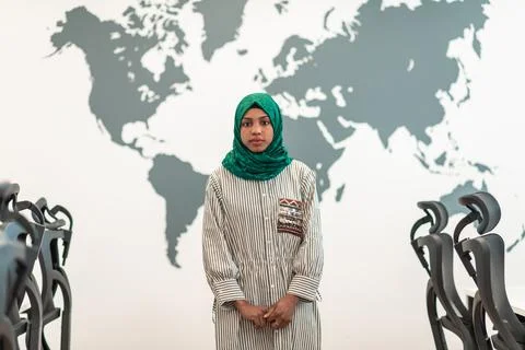 Portrait of muslim female software developer with green hijab standing at modern Stockfoto's