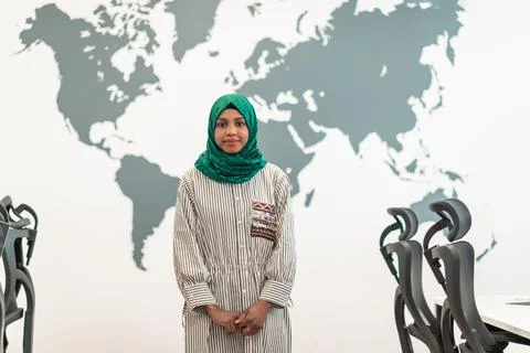 Portrait of muslim female software developer with green hijab standing at modern Stock Photos