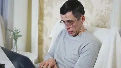 Portrait of a nerd working on laptop Stock Footage 148491460